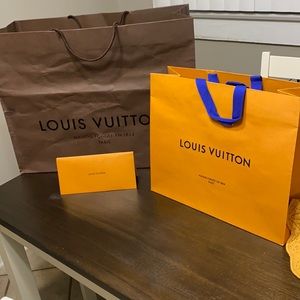 2 Louis Vuitton shopping bags and 1 Louis Vuitton receipt envelope